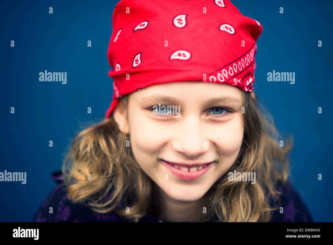 Portrait of smiling girl with red headscarf Stock Photo