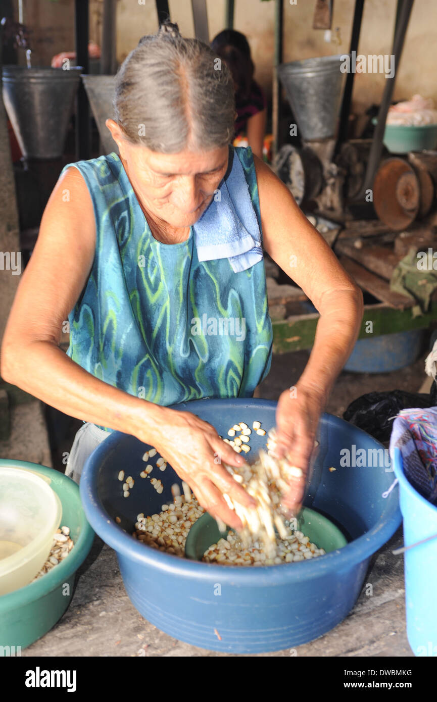 Woman knead corn for tortilla paste at Suchitoto on El Salvador Stock