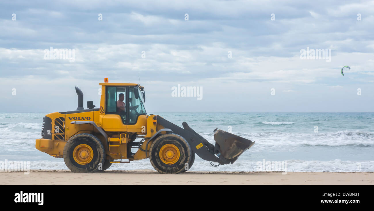 Yellow Power Shovel doing work on the beach of Playa de Palma in November. Mallorca, Balearic islands, Spain, off-season. Stock Photo