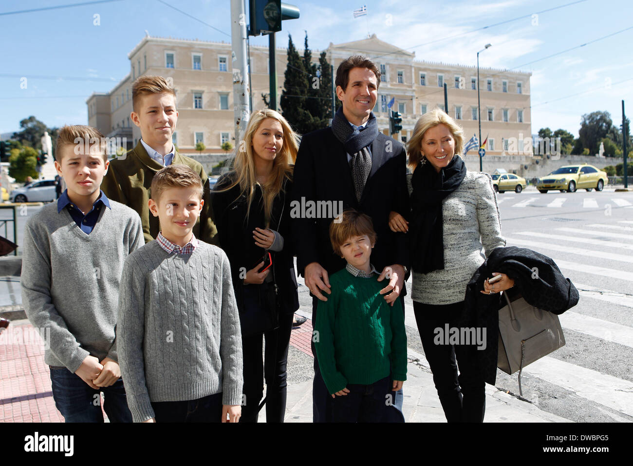 Athens, Greece. 5th Mar, 2014. Prince Pavlos and Marie-Chantel of Greece with their children photographed in the center of Athens with Greek parliament in the background. Greek Royal family arrived in Athens to attend the memorial service for the 50 years since the death of her father, King Paul, to be held Thursday at Tatoi. A day before, on Wednesday afternoon will be held at the auditorium of the Gennadius Library, the official screening of the documentary the ''Paul, an unlikely king'', Greek production, which was made ''‹''‹the occasion of the year, 50 years after the death of King Paul Stock Photo