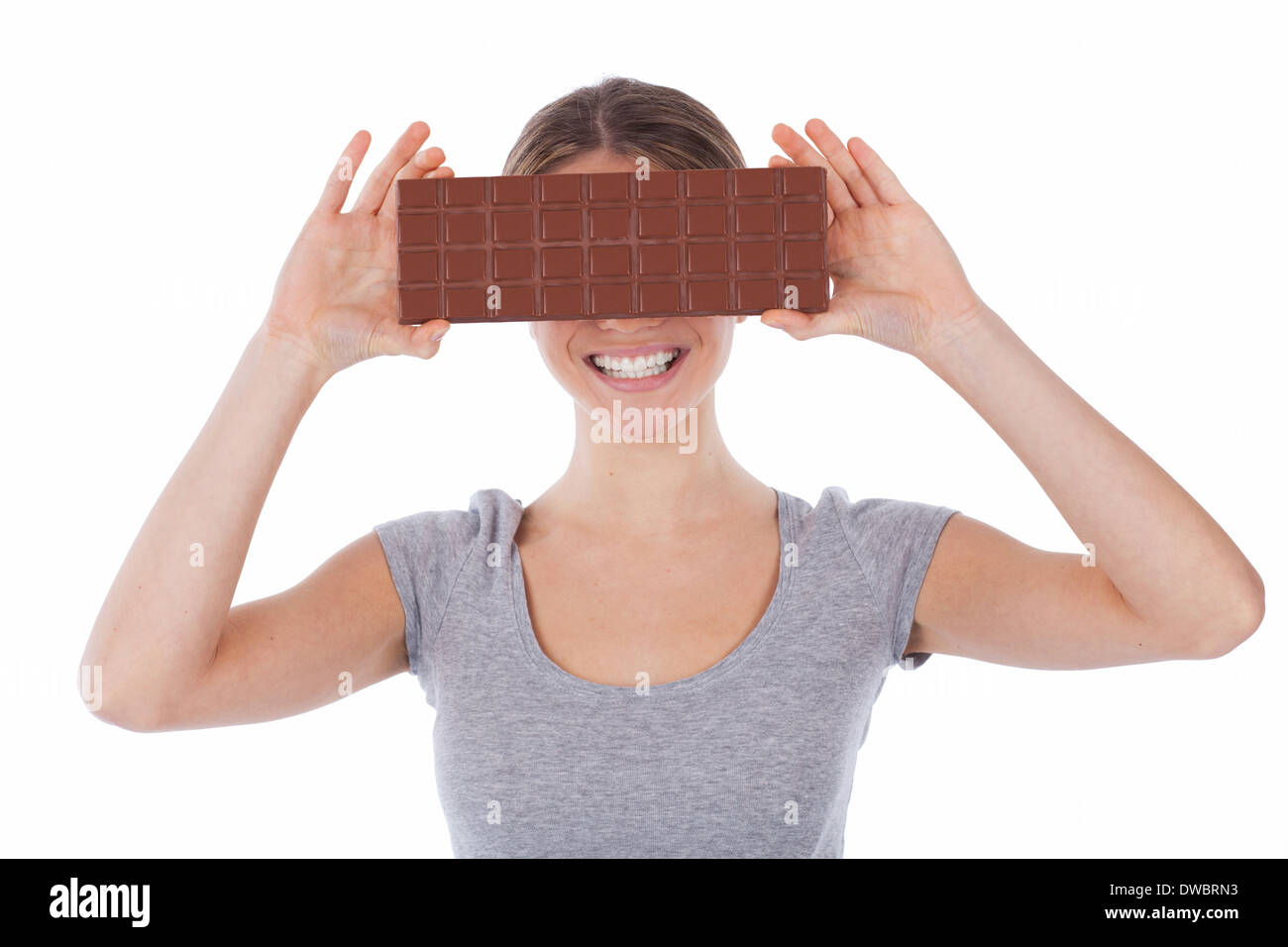 Portrait of a smiling woman holding a chocolate tablet, isolated on white Stock Photo