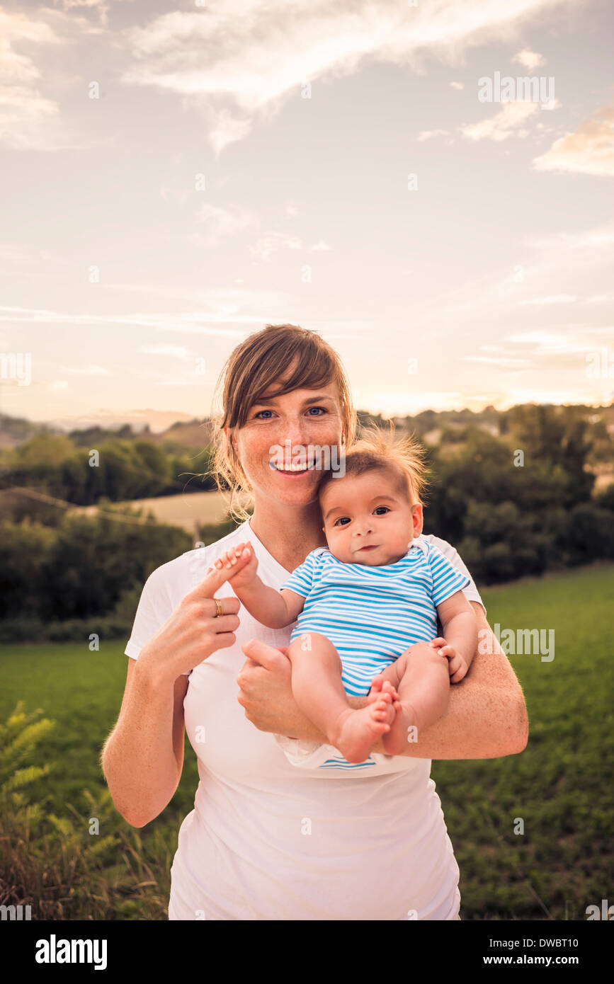 Portrait of baby girl gripping mothers finger Stock Photo