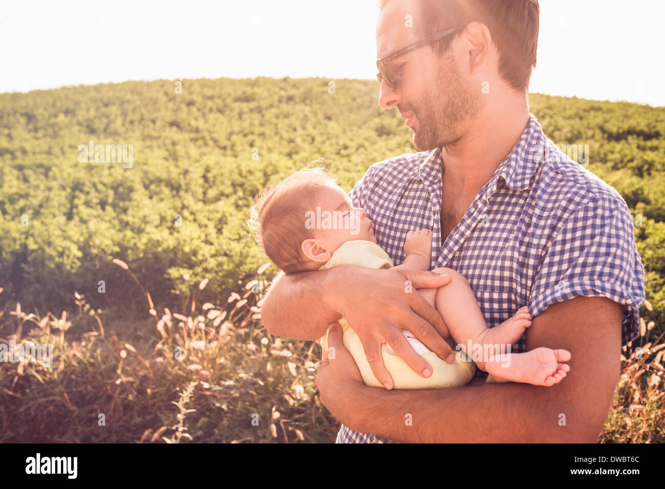 Mid adult man holding baby daughter Stock Photo
