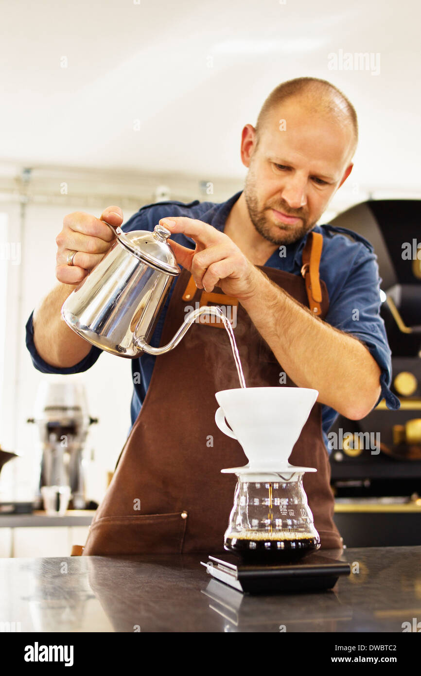 Barista pouring boiling water into coffee filter Stock Photo Alamy