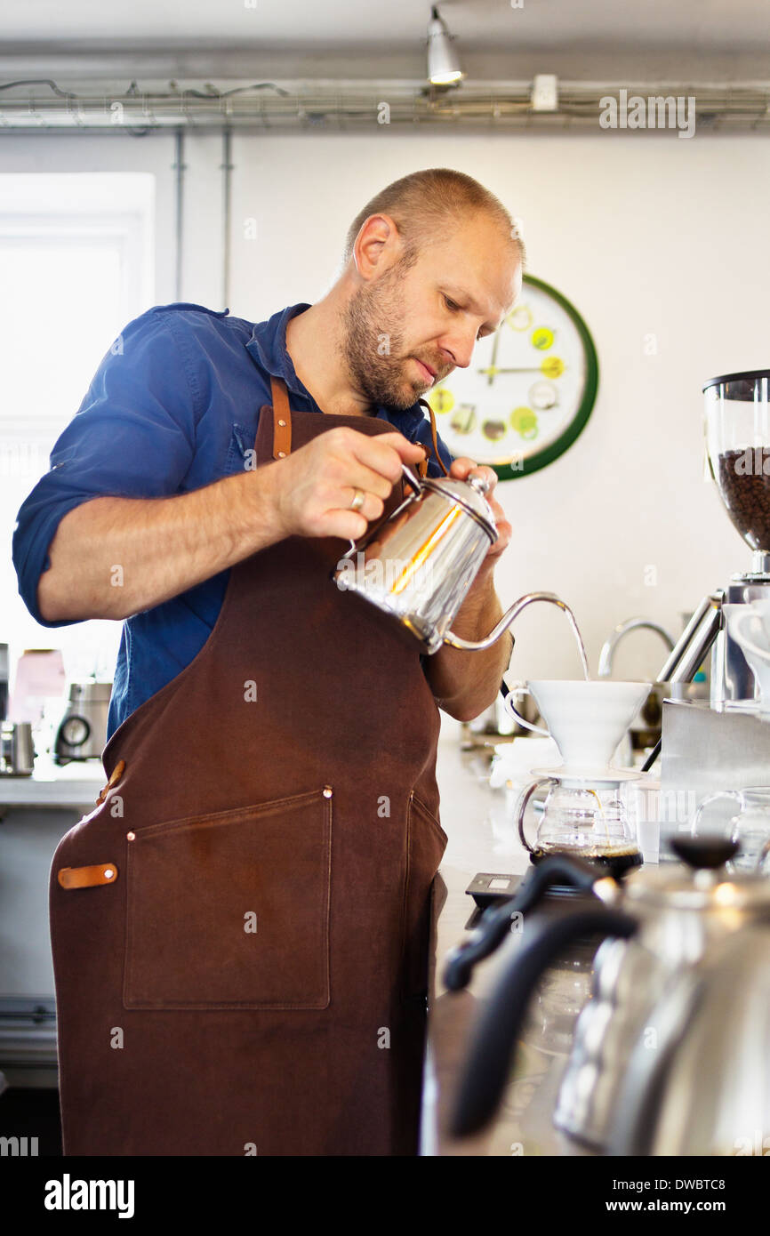 Male barista pouring boiling water into coffee filter Stock Photo Alamy