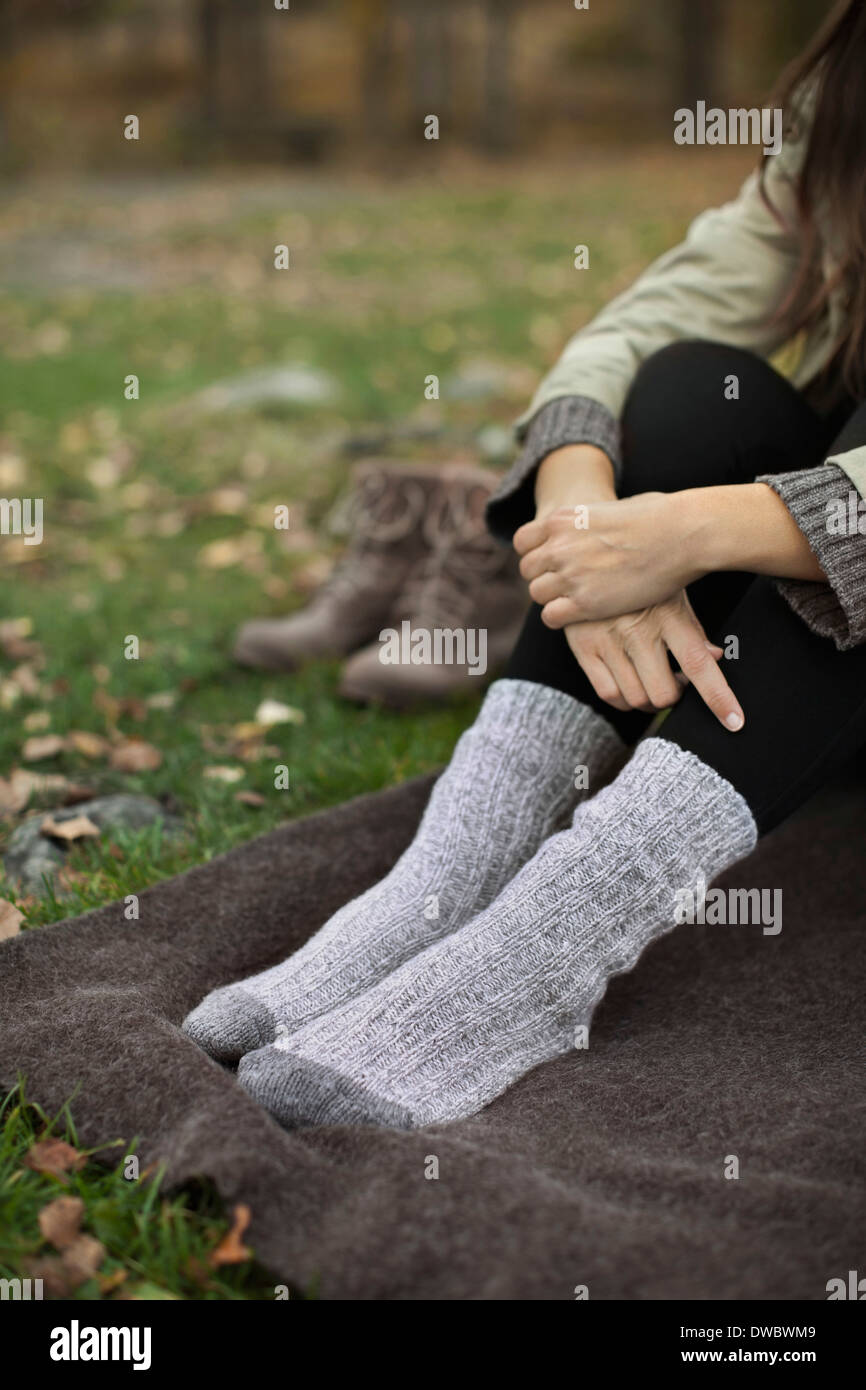 Low section of woman wearing socks sitting on blanket while camping Stock  Photo - Alamy