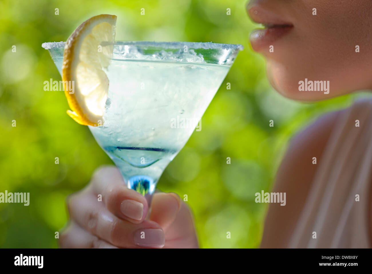 Woman holding glass of margarita to mouth Stock Photo