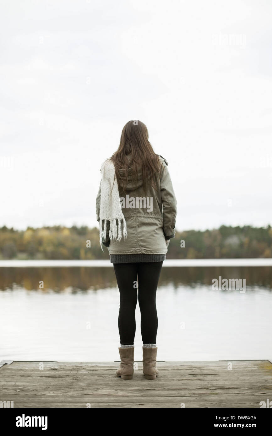 Rear view of woman standing on pier Stock Photo