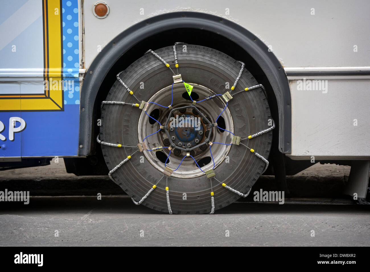 A New York City bus with chains on its tires for traction in the snow