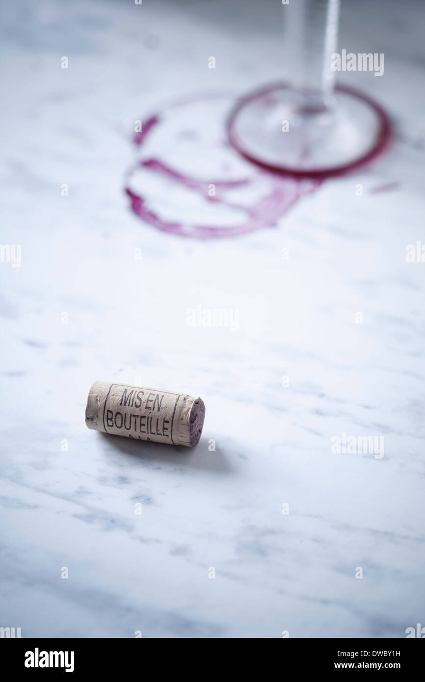 Red wine glass, stains and wine cork on white marble Stock Photo Alamy