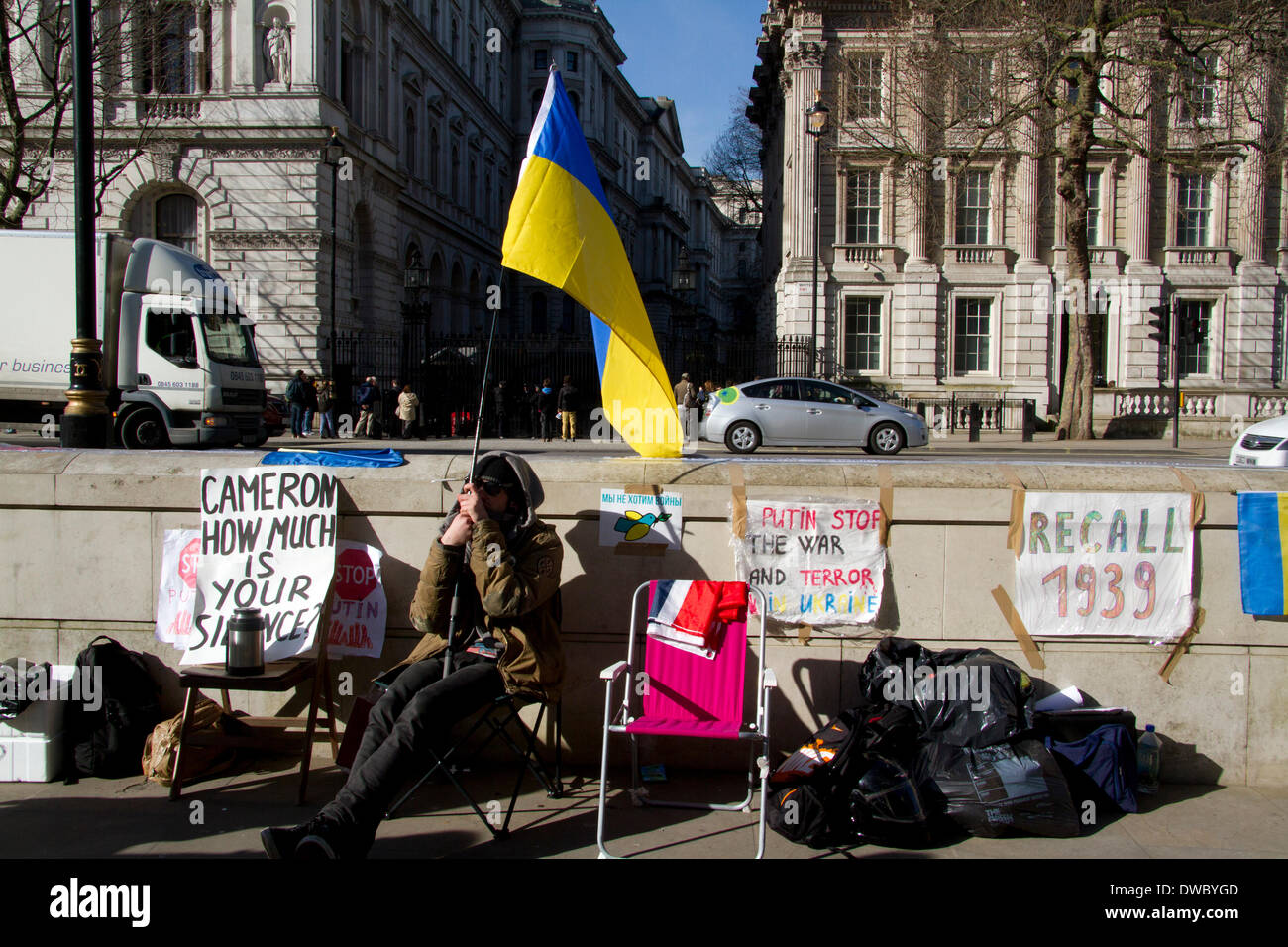 Westminster London ,UK. 5th March 2014. Ukrainian protesters continue to hold a 24hour shift protest outside Downing Street with placards following the Russian military intervention in the Crimea demanding on the British Government to keep its promises on the Budapest memorandum on Security Assurances signed in 1994. Credit:  amer ghazzal/Alamy Live News Stock Photo