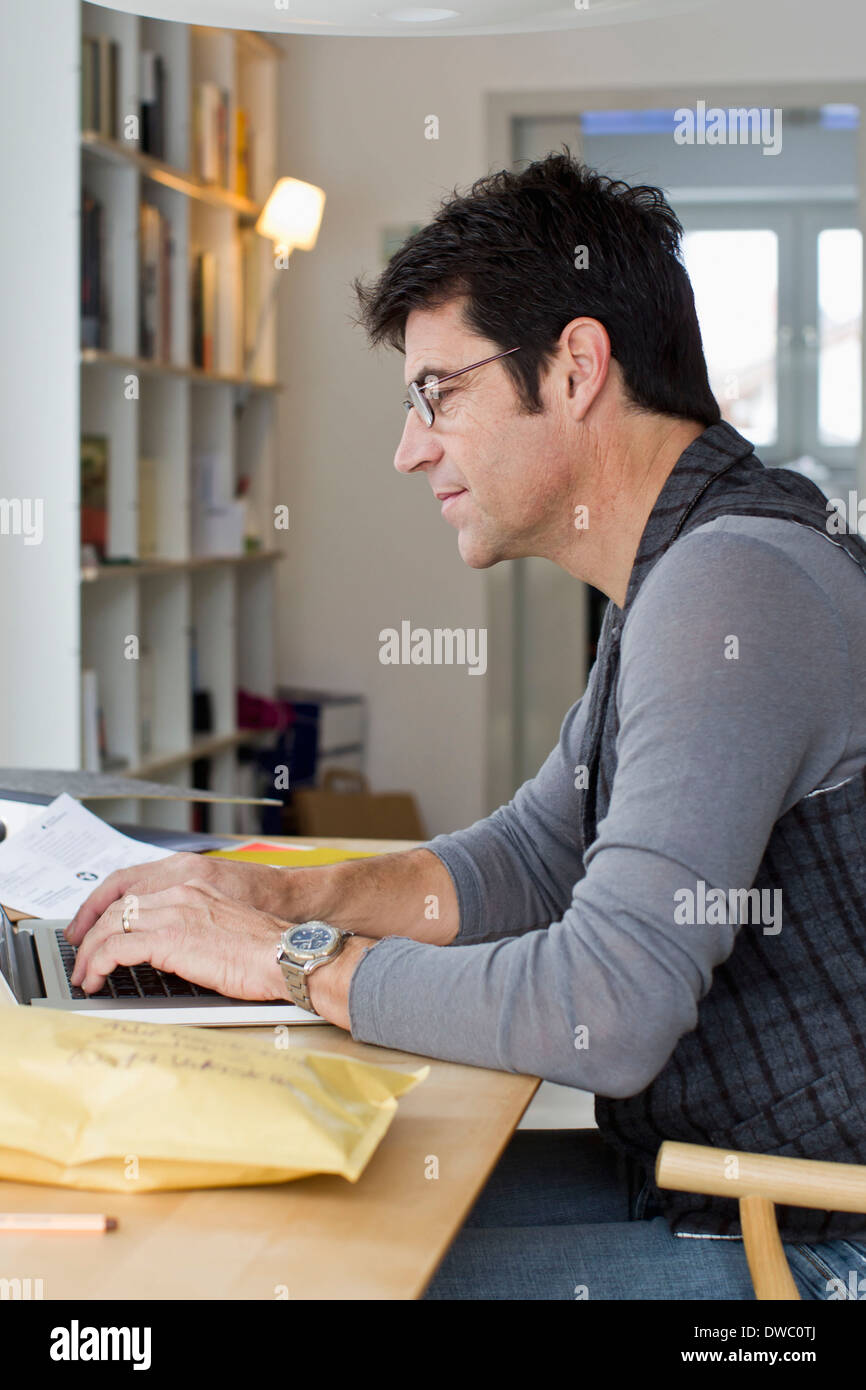 Mature adult laptop desk home hi-res stock photography and images - Alamy