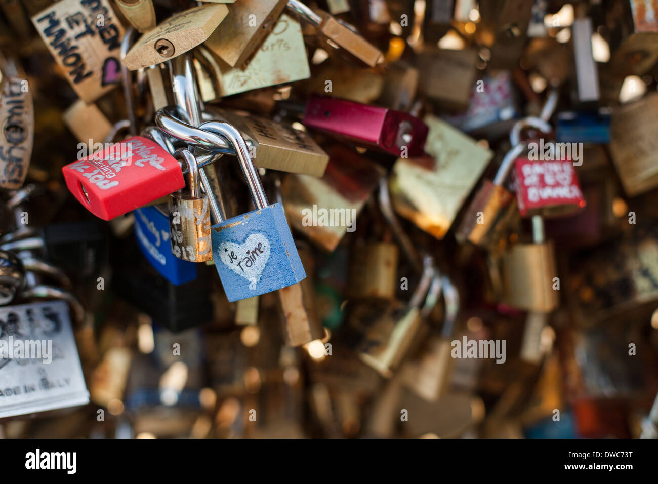 Detail of padlocks on the the Pont des Artes, focused on one that reads 'je t'aime' - French for 'I love you'. Stock Photo
