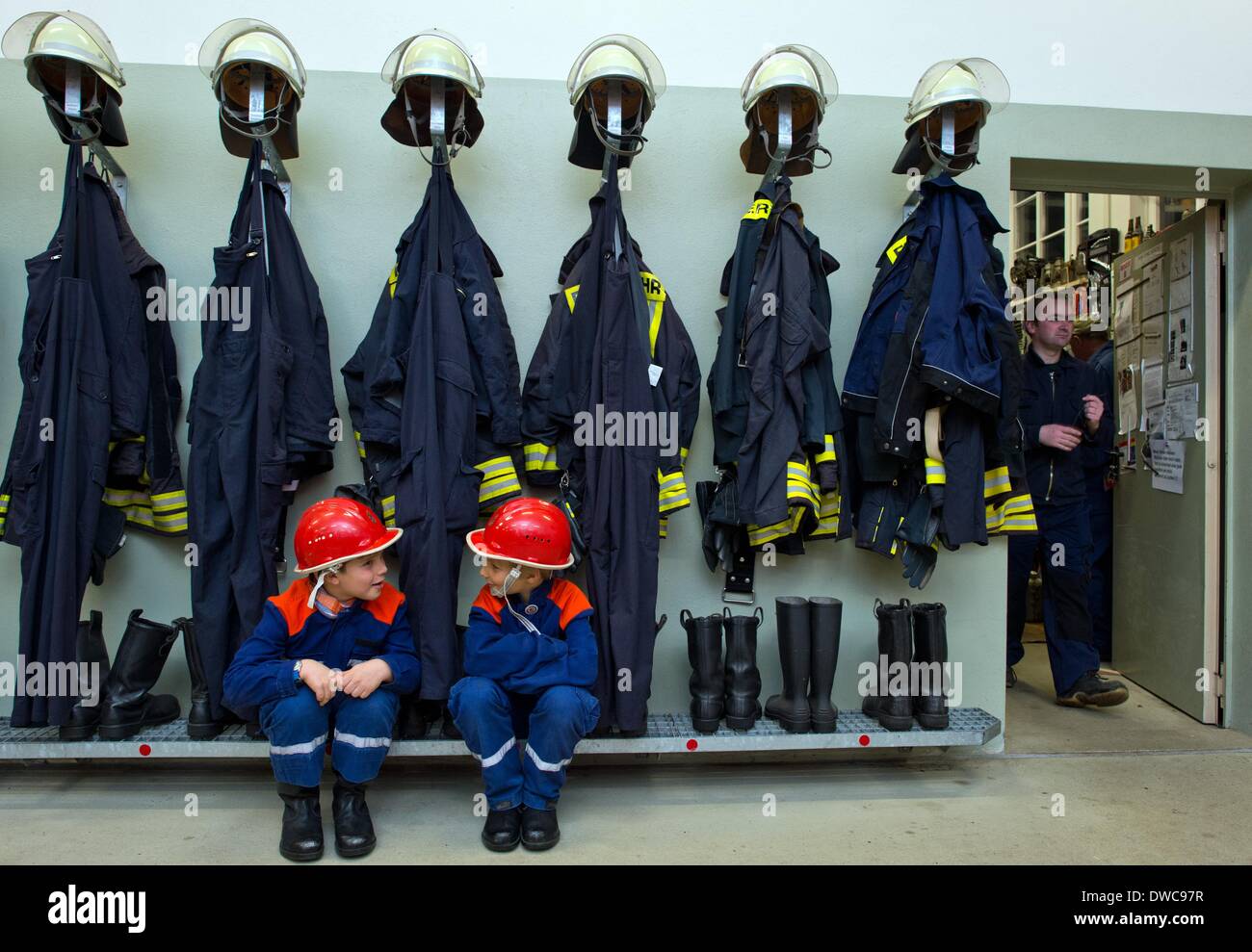 Eight-year-olds Arian (L) and Niclas sits in their children's uniforms at the volunteer fire department in Kistow in Frankfurt Oder, Germany, 27 February 2014. Every 14 days, the young fire fighters meet for training at the fire department. Even though there isn't a shortage of new recruits in Klitsow, but the situation is different at the fire dpartments in the rest of the state. In Brandenburg there are around 48,000 fire fighters and most of them are volunteers. This number will sink as well along with the change in demographics. Photo: Patrick Pleul Stock Photo