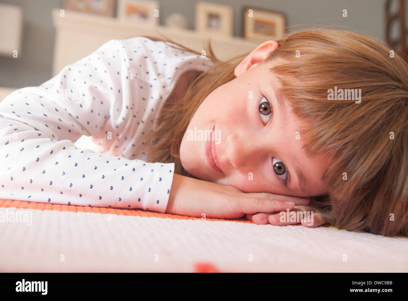 Close up portrait of girl lying on rug Stock Photo Alamy