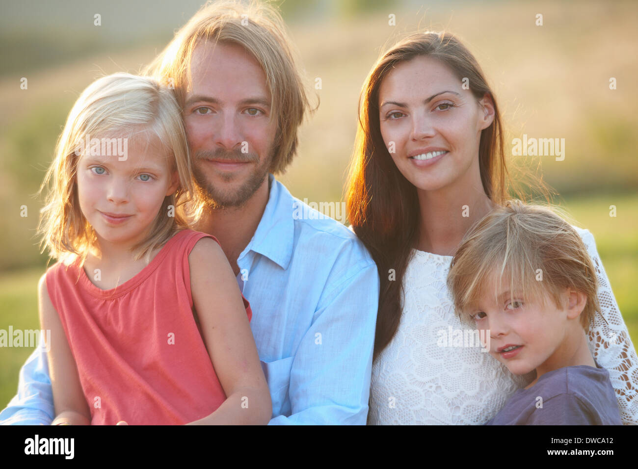 Portrait of mid adult couple and two children outdoors Stock Photo