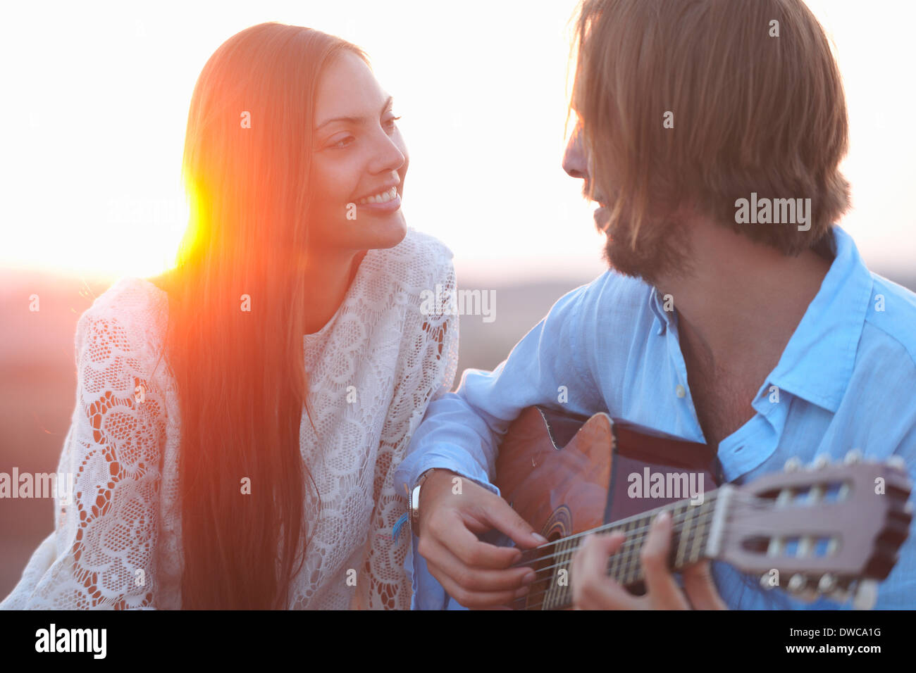 Portrait of mid adult couple with acoustic guitar Stock Photo