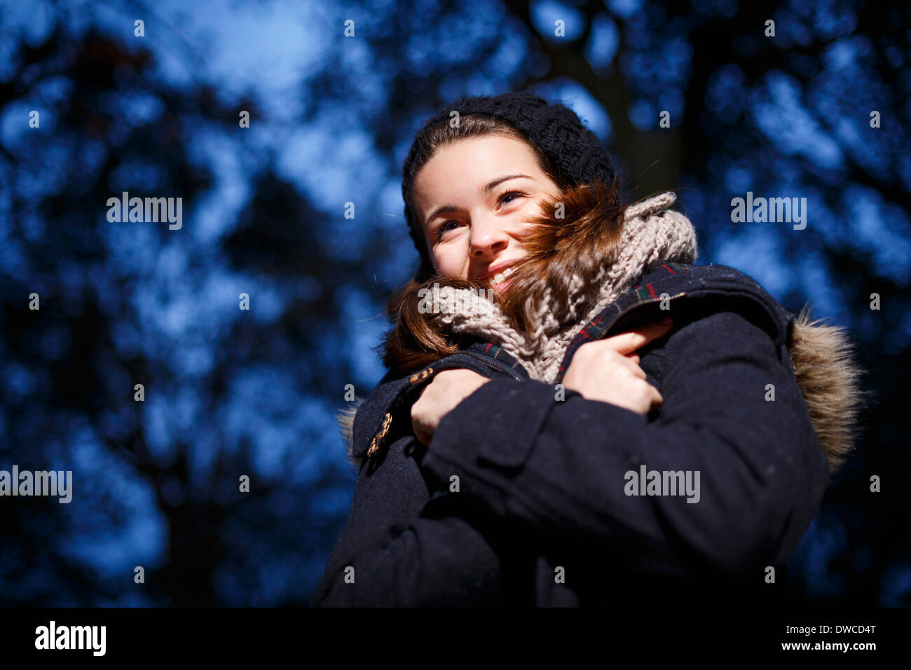 Teenage girl in forest at dusk Stock Photo