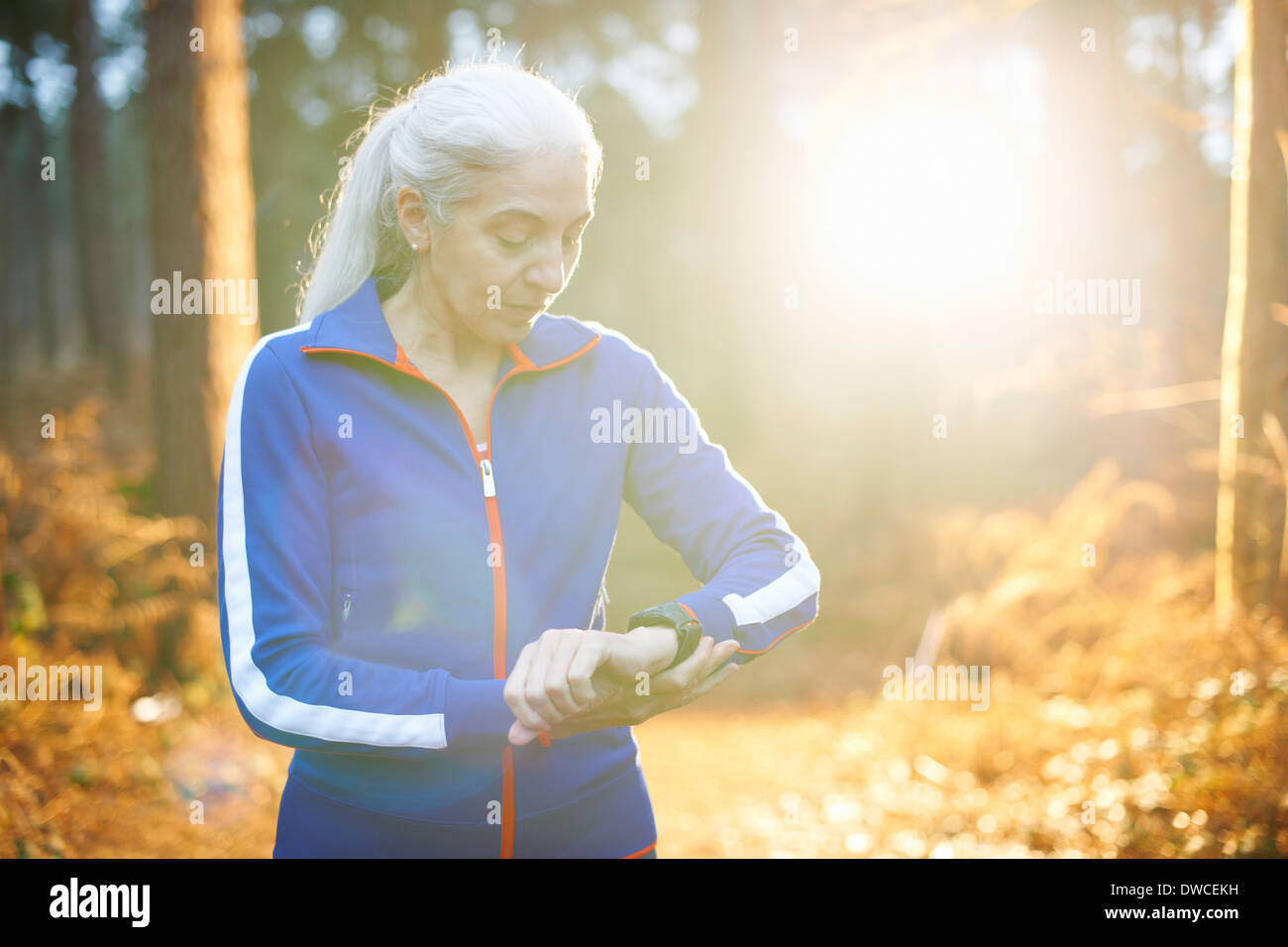 Mature woman wearing tracksuit top checking the time Stock Photo Alamy