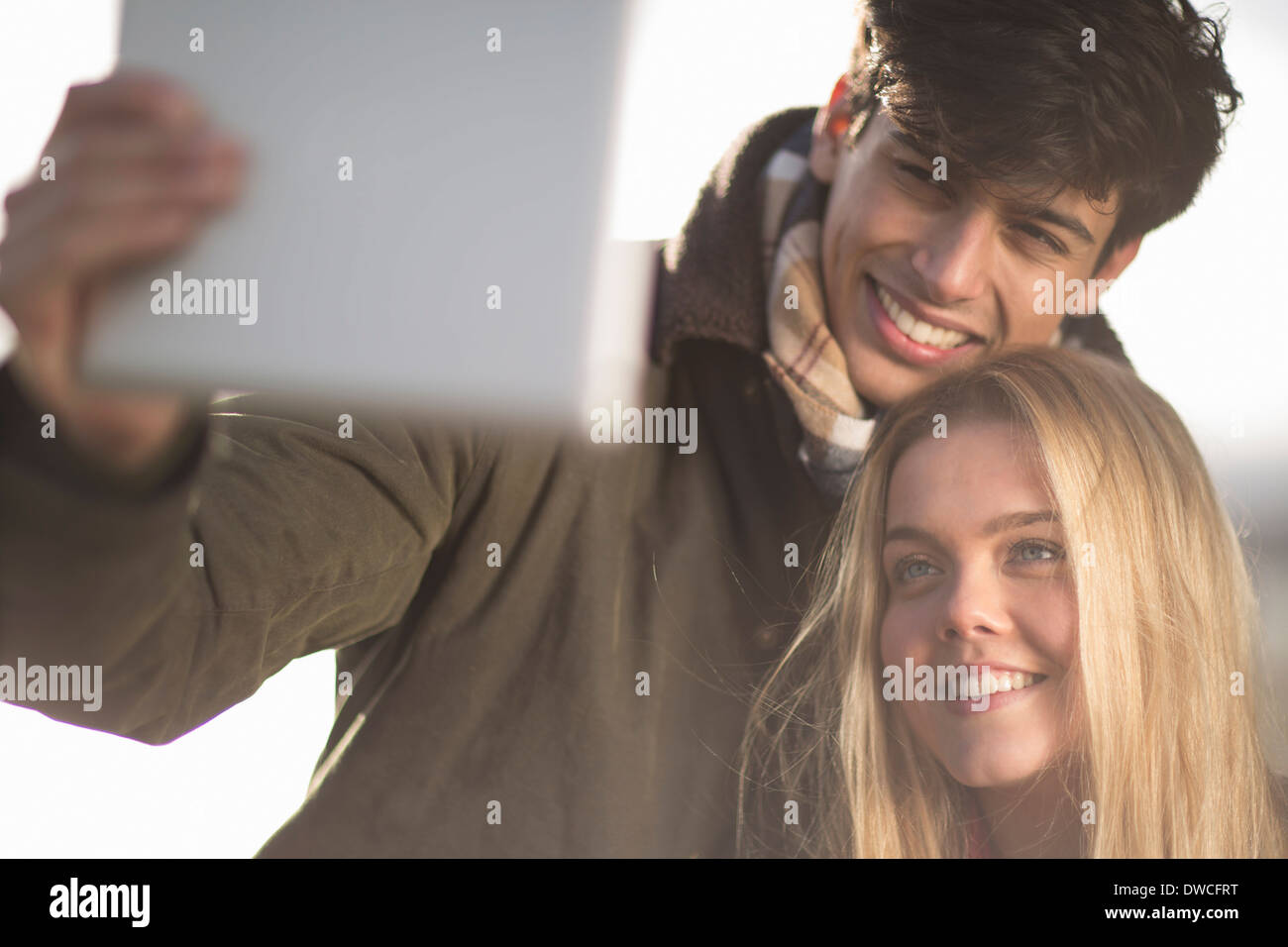 A young couple take self portrait photograph using digital tablet Stock Photo