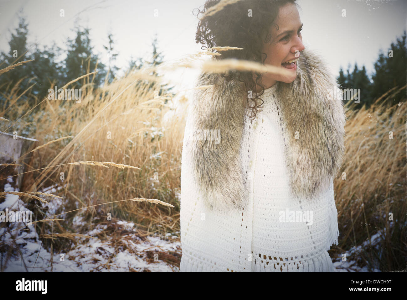 Mid adult woman wearing fur collar in forest Stock Photo