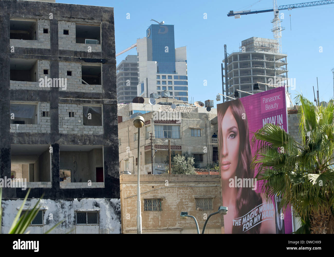 Amman, Jordan. 01st Mar, 2014. An large advertisement with the protrait of a woman hangs between homes and offices in Amman, Jordan, 01 March 2014. Photo: SOEREN STACHE/dpa/Alamy Live News Stock Photo