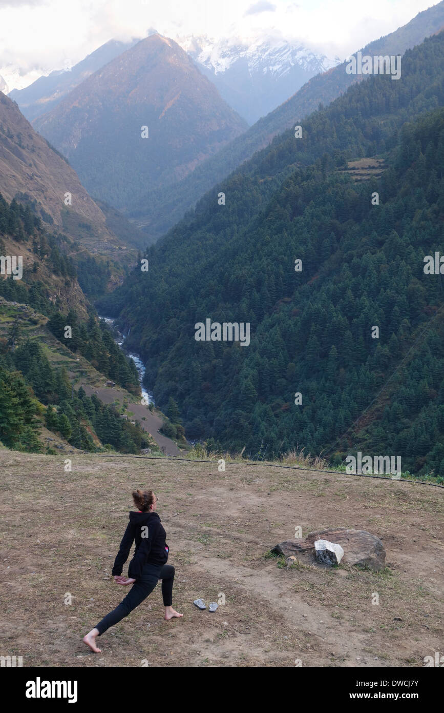 Trekkier doing yoga at a campsite in the Tsum Valley, Nepal. Stock Photo