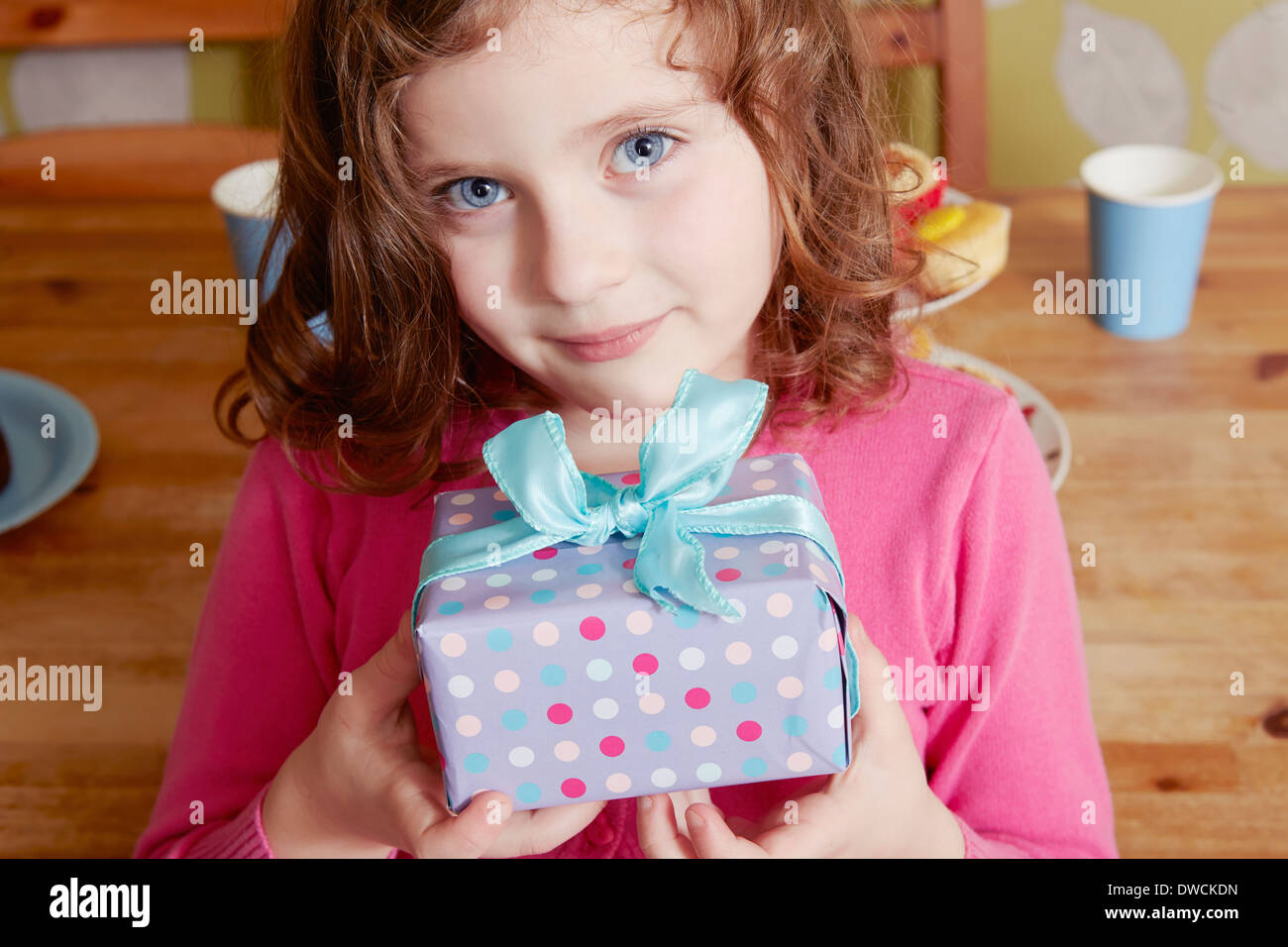 Portrait of girl holding birthday present Stock Photo - Alamy