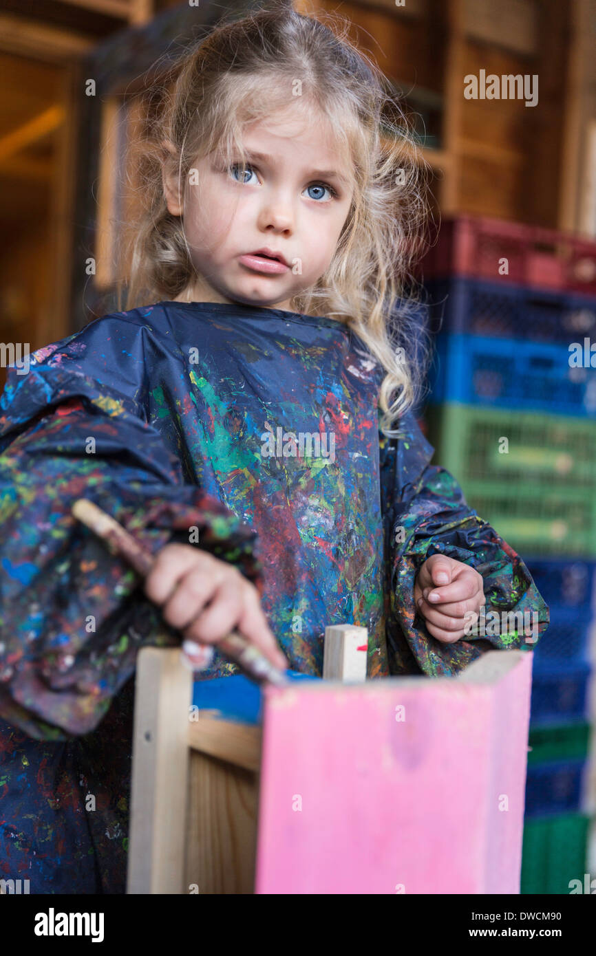 Girl painting wooden house Stock Photo Alamy