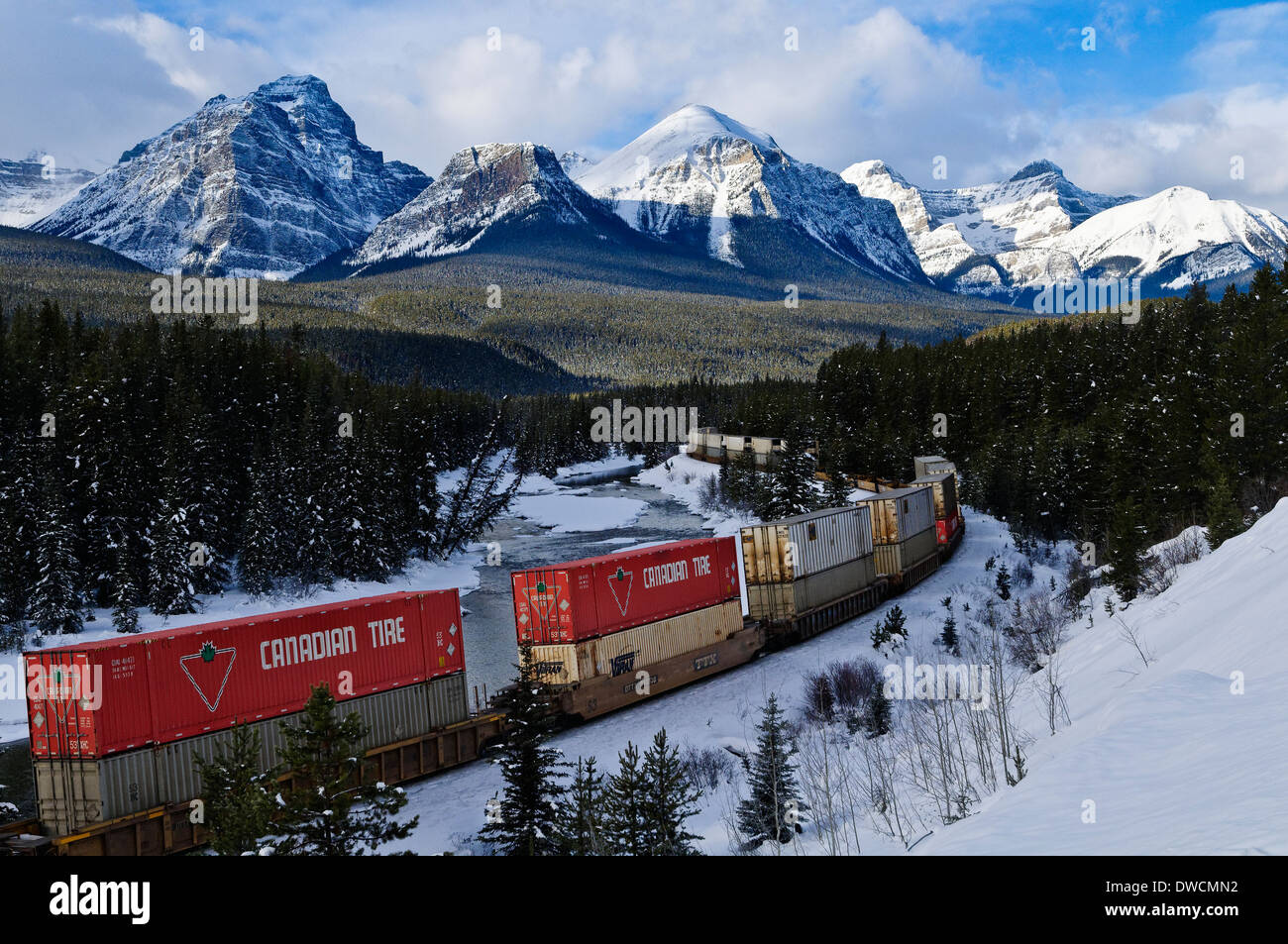 Train at Morant's curve with Haddo Peak, Saddle Mountain, Fairview Mountain in the background, Banff National Park Stock Photo
