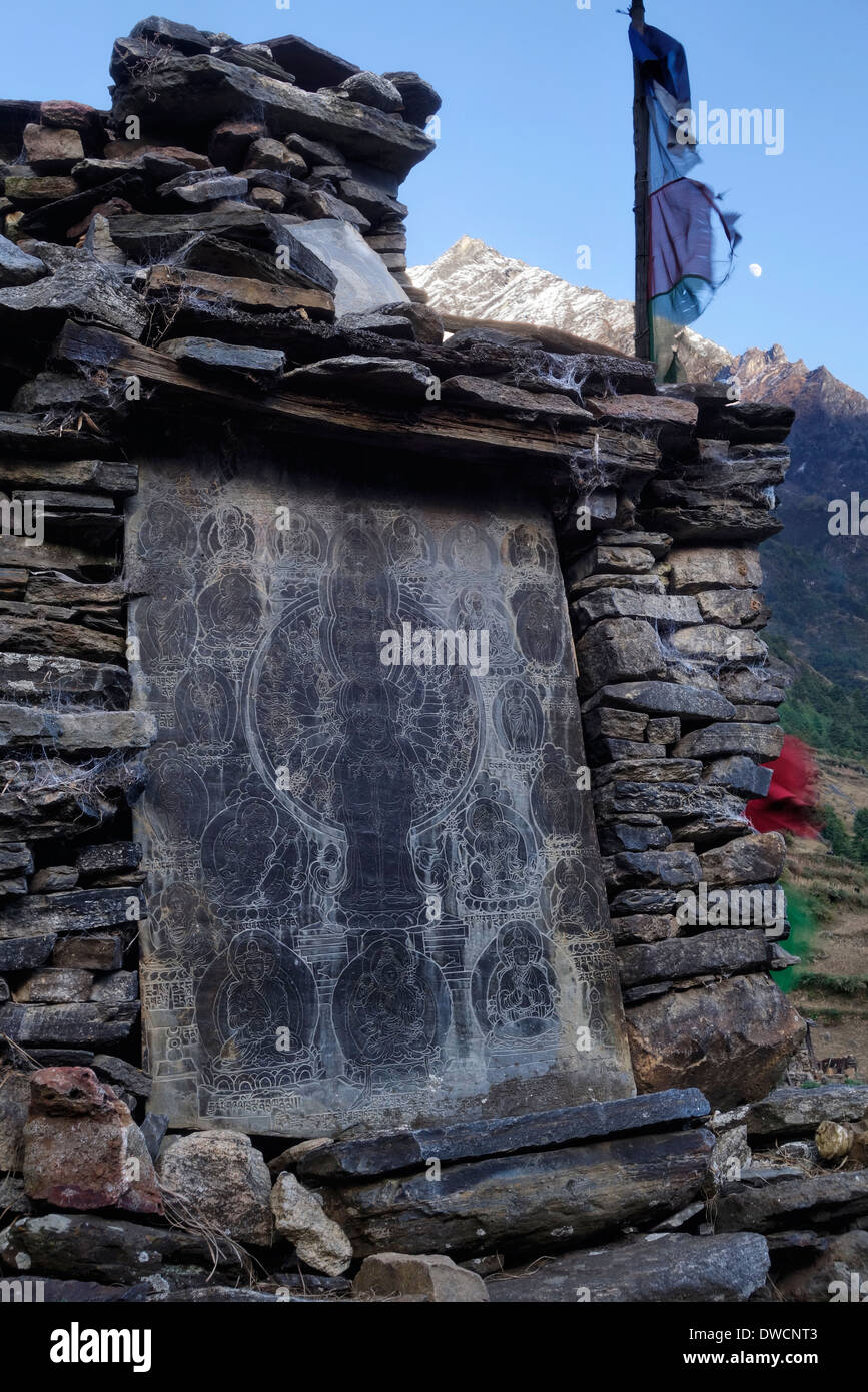 Mani stone at the base of a stupa in the Manaslu region of Nepal. Stock Photo