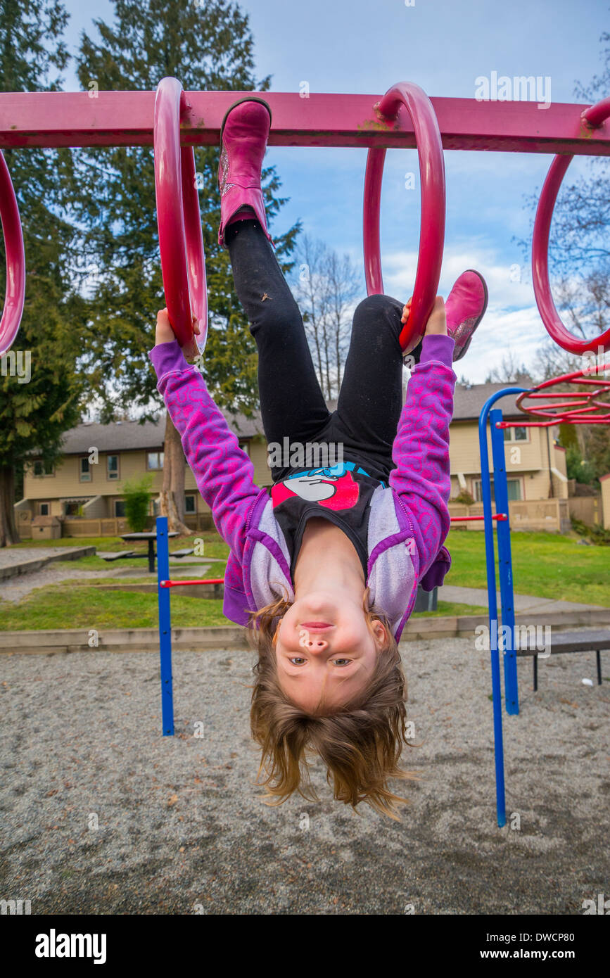 Kids Using Playground Rings Child in playground on rings, bars Stock Photo - Alamy