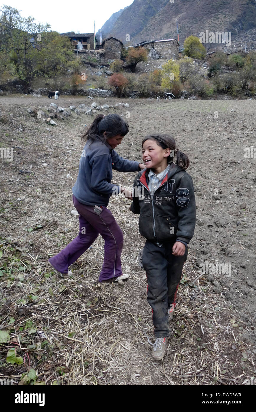 Girls playing in a field, Ngakyu Leru, Nepal Stock Photo