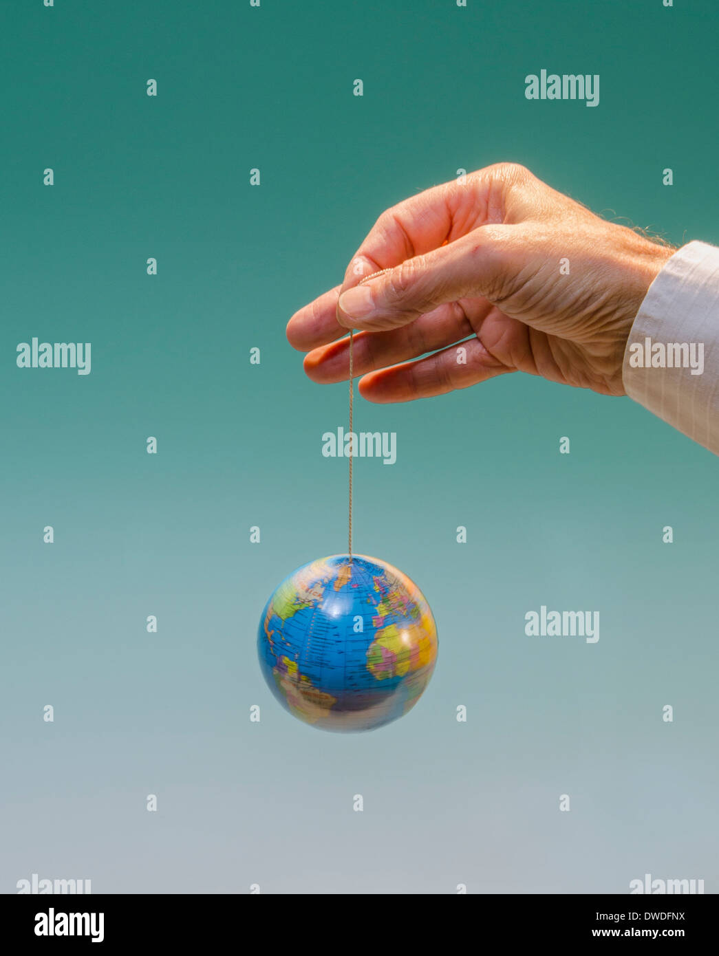 hand with dangling globe with Atlantic Ocean prominent Stock Photo