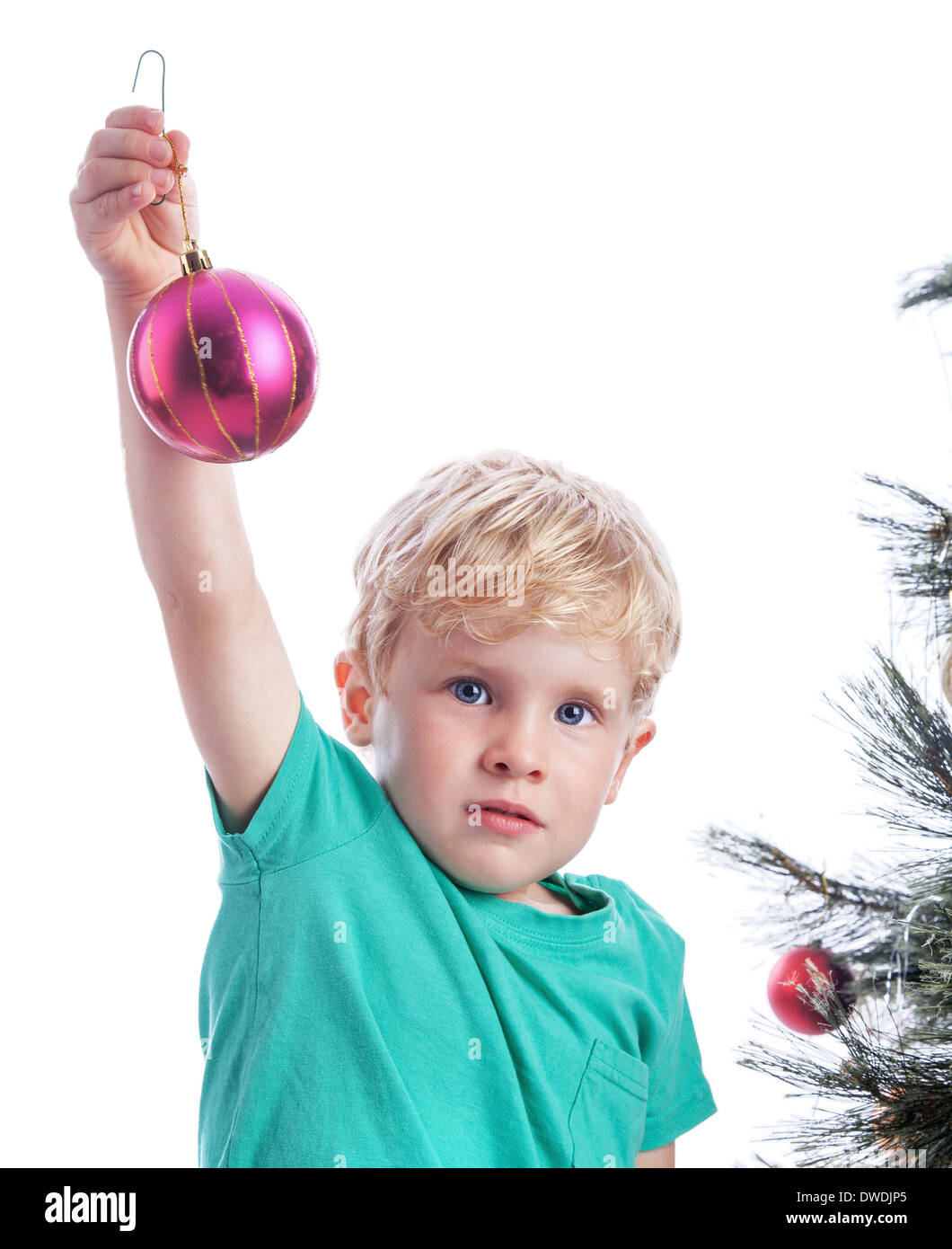 Preschooler showing a Christmas purple decoration before he puts it on