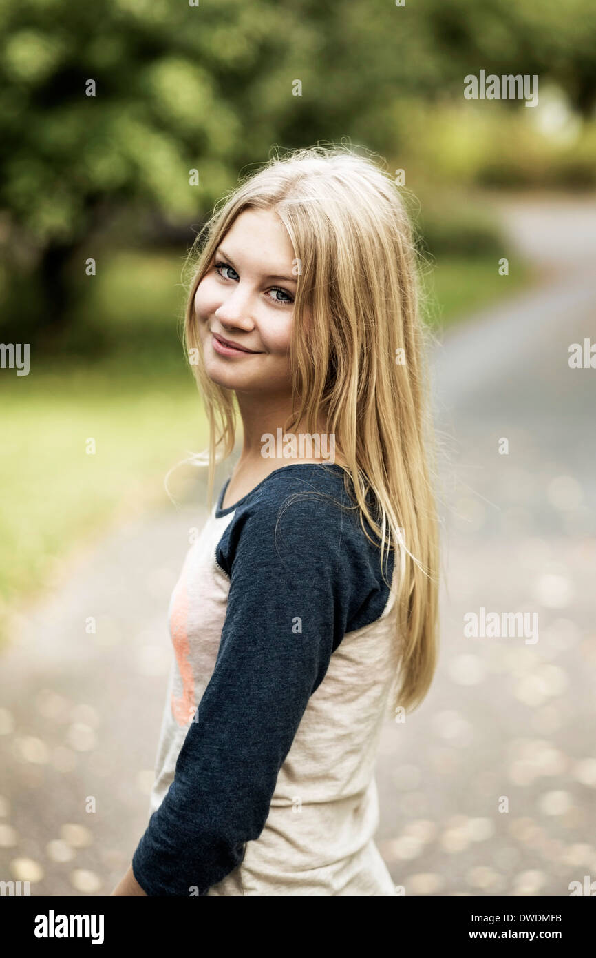 Portrait of smiling teenage girl standing on street Stock Photo - Alamy