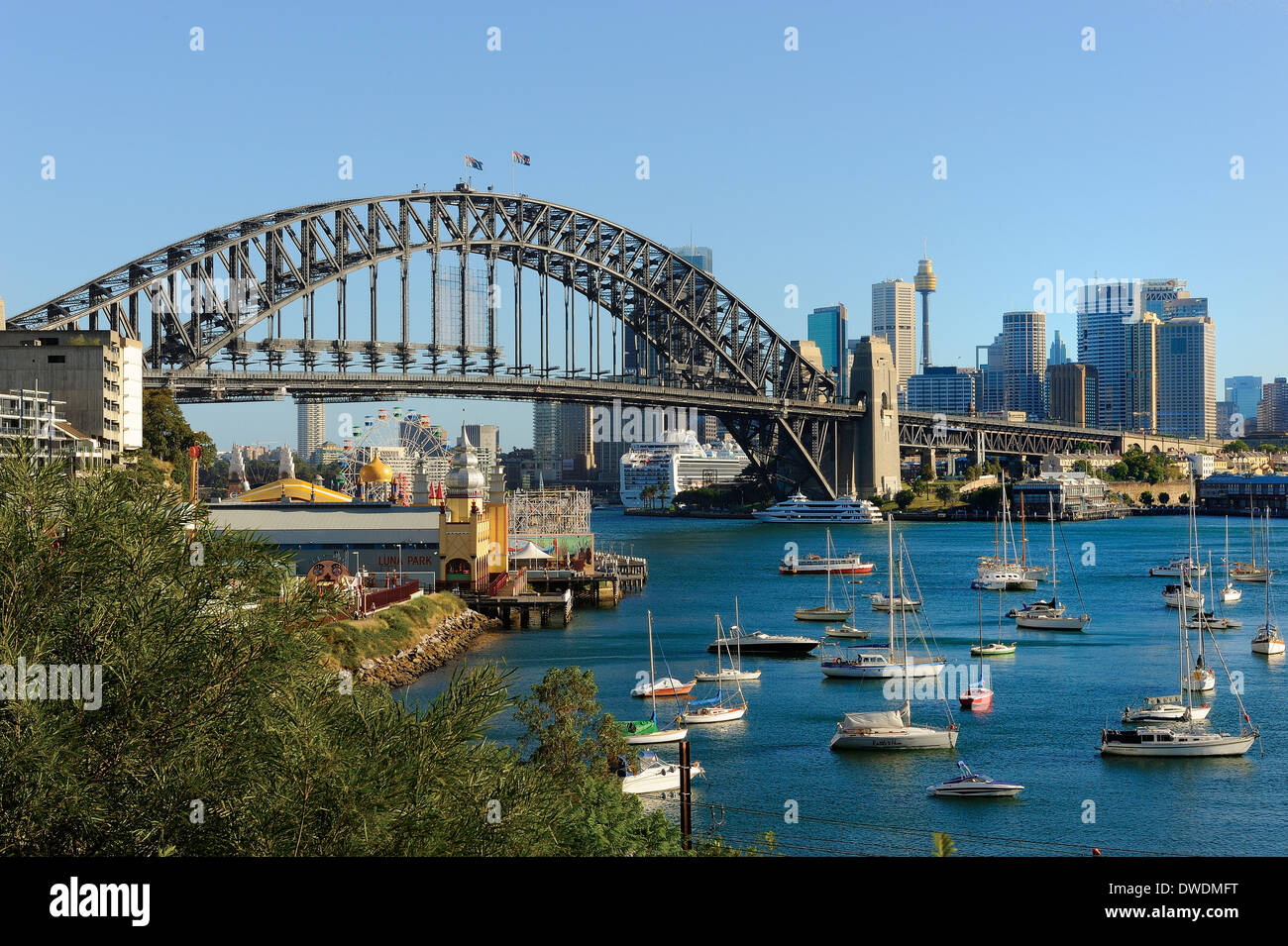 The Harbor Bridge of Sydney Australia and harbor showing Luna Park and small boats. Stock Photo
