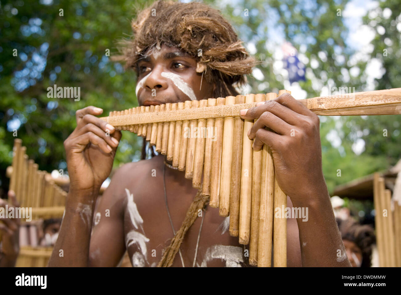 Boys perform on their handmade bamboo mouth harps at Nggela Island, Roderick Bay, Solomon Islands Stock Photo