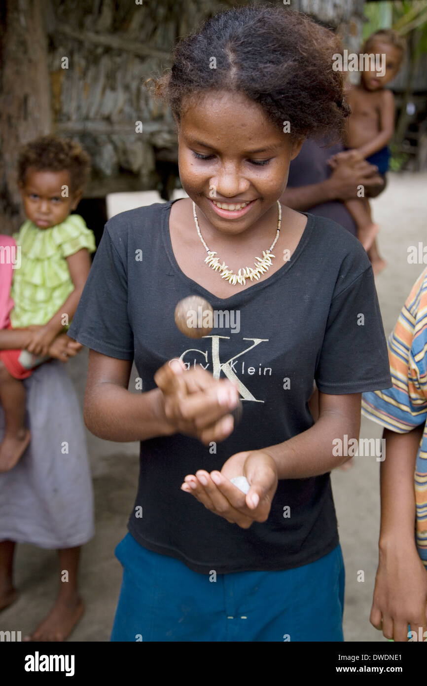 'Pagwa' is a popular game similar to jacks played by girls in the Solomon Islands, Santa Ana Island, Solomon Islands. Stock Photo
