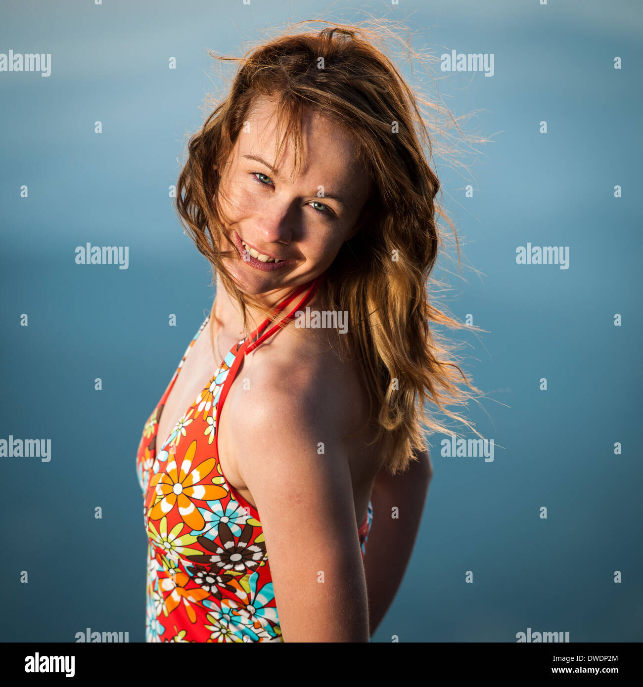 Outdoor portrait of beautiful young woman in short summer dress at ...