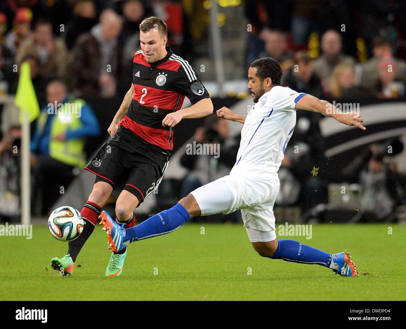Stuttgart, Germany. 05th Mar, 2014. Germany's Kevin Grosskreutz vies for the ball with Chile's Jean Beausejour during the international friendly match between Germany and Chile at Mercedes-Benz-Arena in Stuttgart, Germany, 05 March 2014. Photo: Bernd Weissbrod/dpa/Alamy Live News Stock Photo