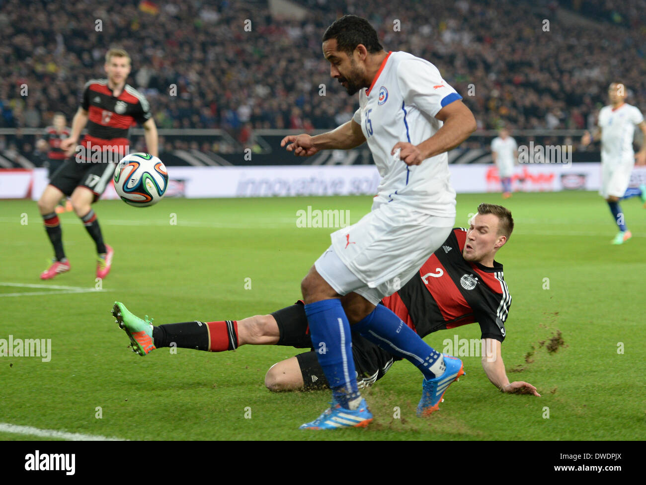 Stuttgart, Germany. 05th Mar, 2014. Germany's Kevin Großkreutz (R) vies for the ball with Chile's Jean Beausejour during the international friendly match between Germany and Chile at Mercedes-Benz-Arena in Stuttgart, Germany, 05 March 2014. Photo: Andreas Gebert/dpa/Alamy Live News Stock Photo