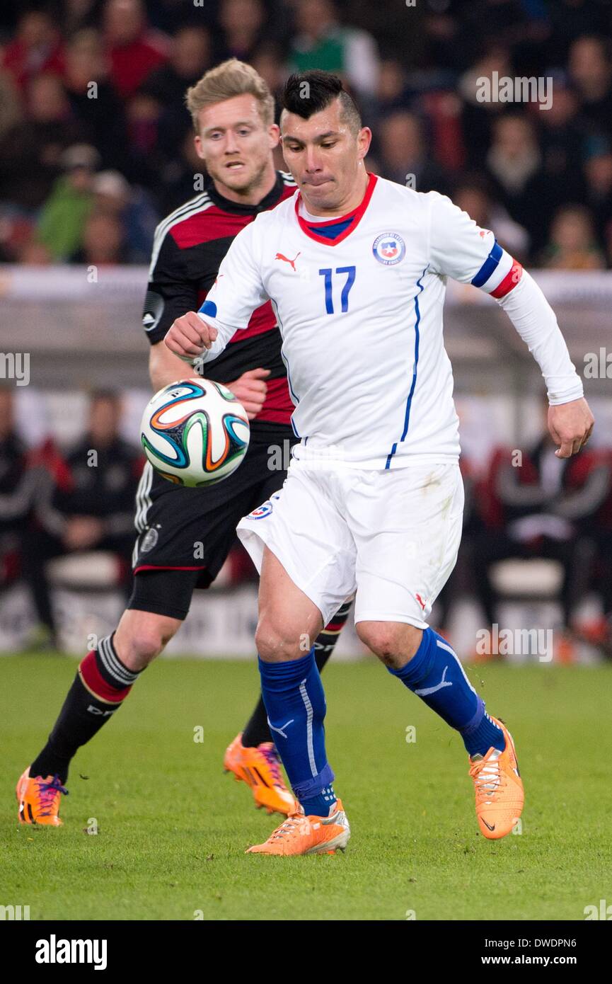 Stuttgart, Germany. 05th Mar, 2014. Germany's Andre Schuerrle (L) vies for the ball with Chile's Gary Medel during the international friendly match between Germany and Chile at Mercedes-Benz-Arena in Stuttgart, Germany, 05 March 2014. Photo: Patrick Seeger/dpa/Alamy Live News Stock Photo