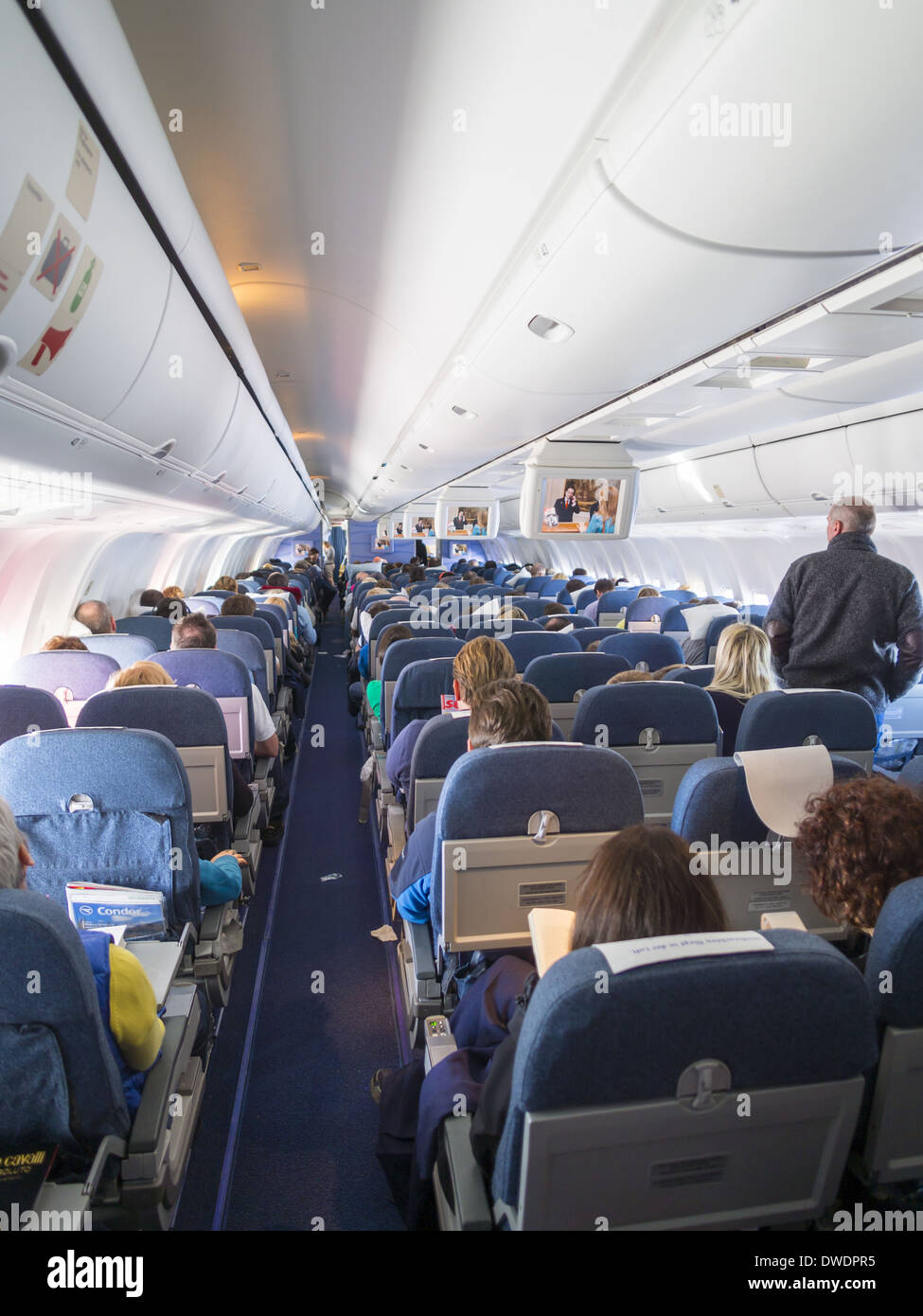 Cabin of aircraft Boing 767 with passengers Stock Photo