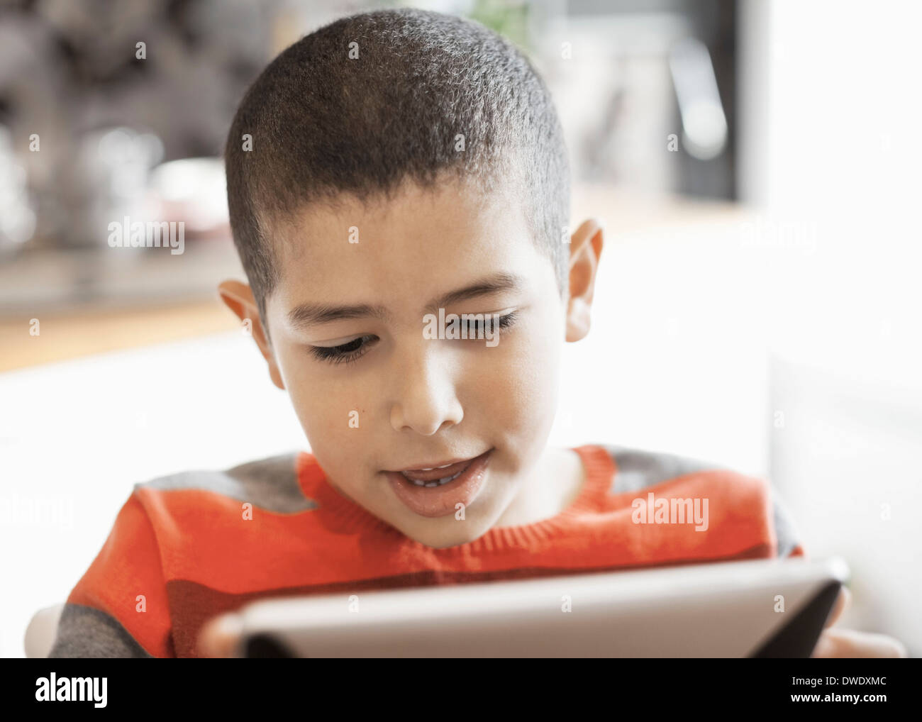 Muslim boy using digital tablet at home Stock Photo - Alamy