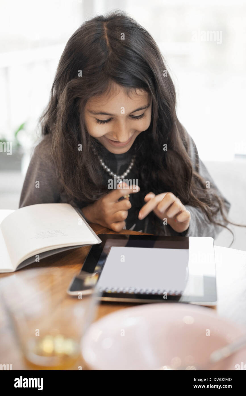 Happy girl using digital tablet at home Stock Photo