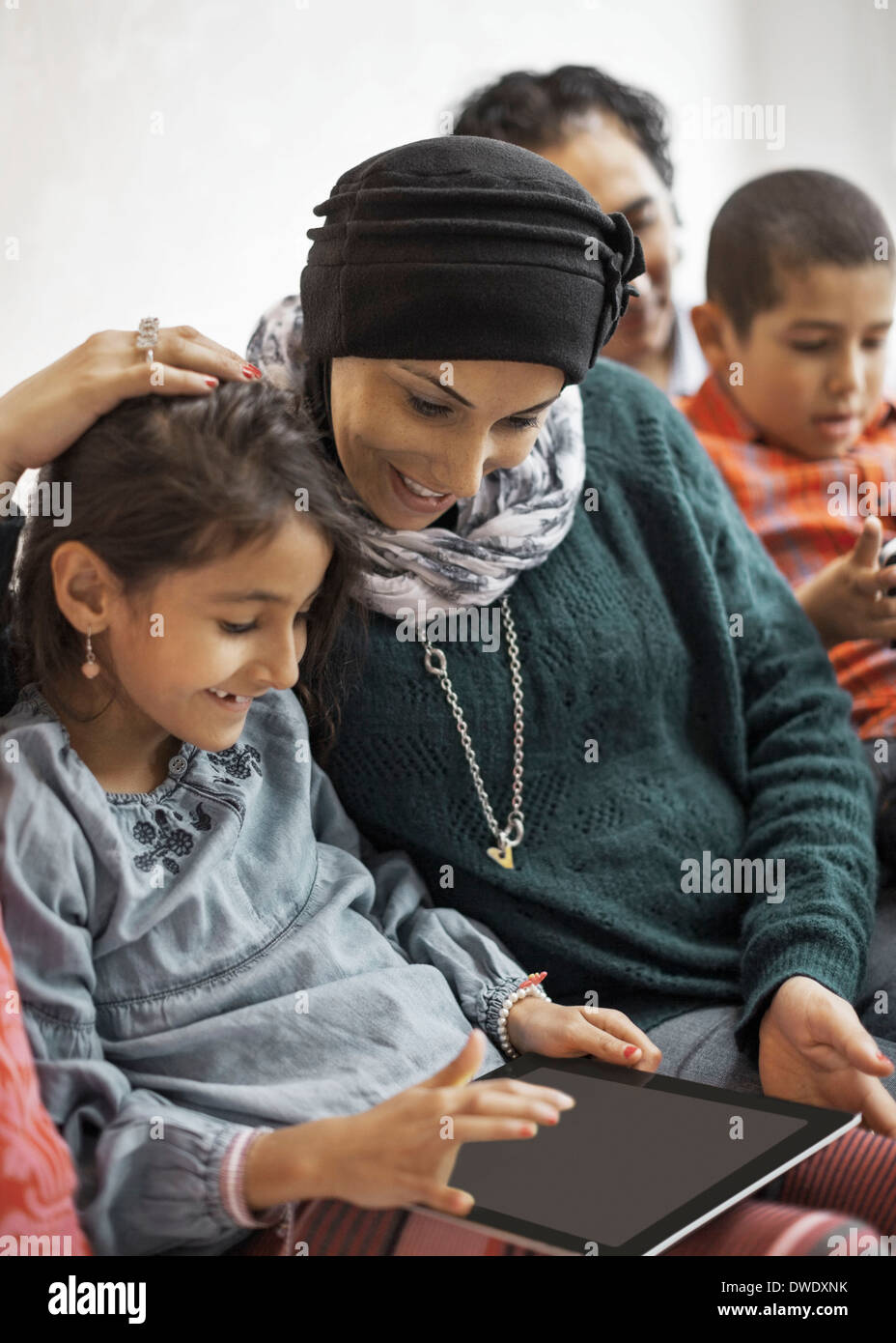 Family using digital tablet at home Stock Photo