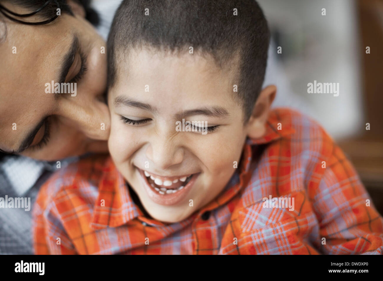 Loving father kissing son at home Stock Photo