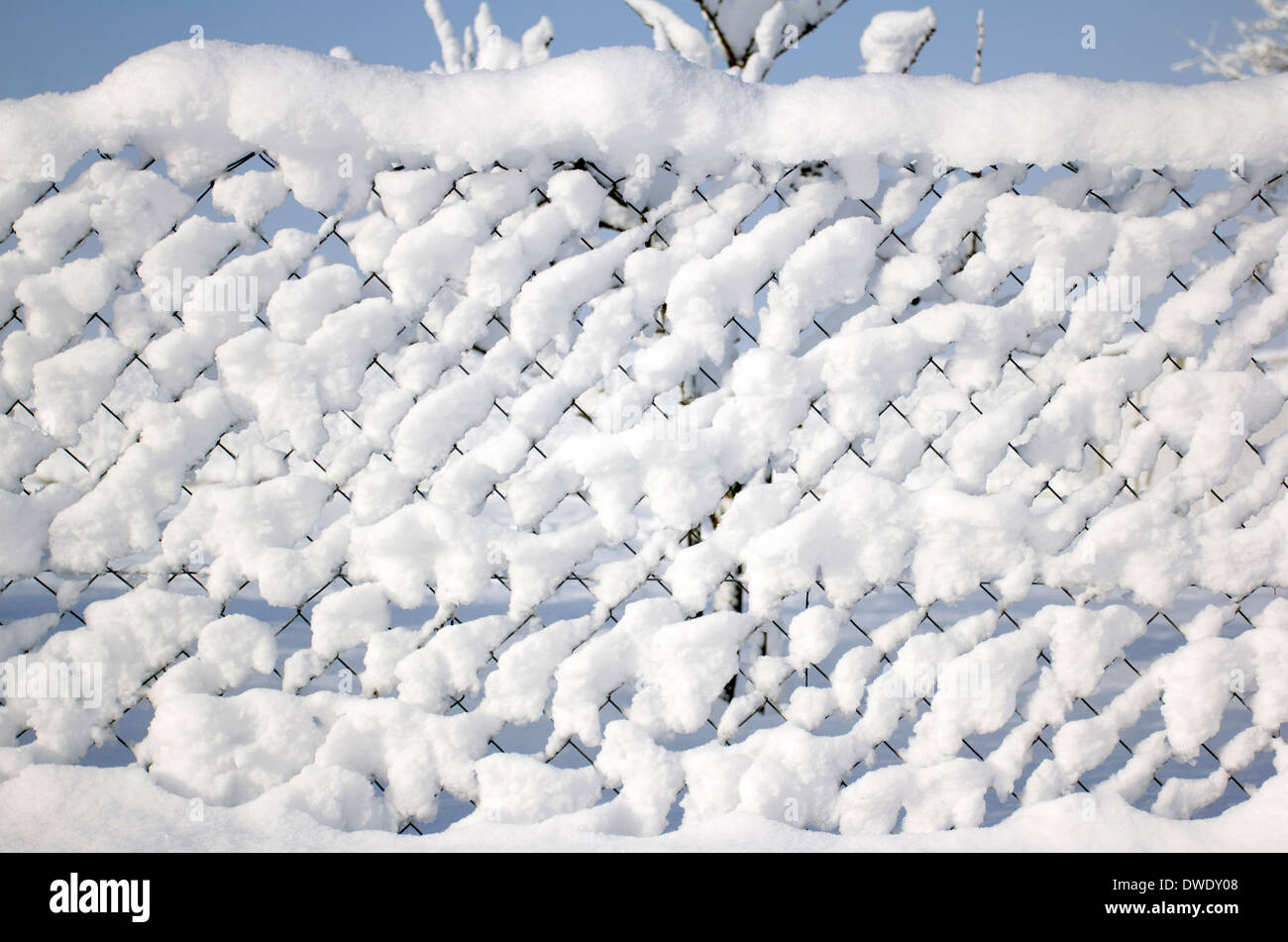 Wire fence covered with fresh snow. Stock Photo