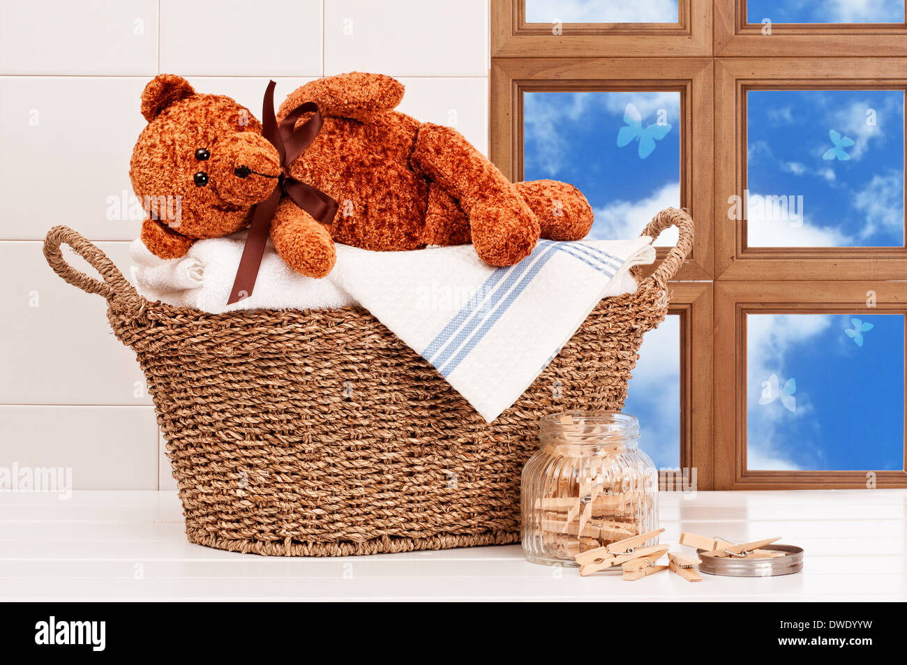 Laundry basket with freshly laundered white towels and teddy bear Stock Photo Alamy